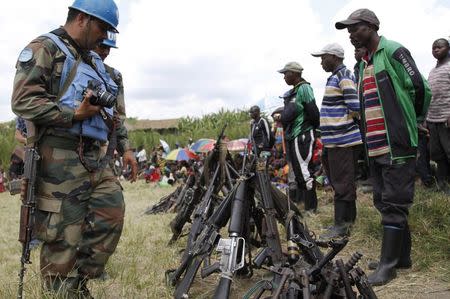 United Nations peace keepers record details of weapons recovered from the Democratic Forces for the Liberation of Rwanda (FDLR) militants after their surrender in Kateku, a small town in eastern region of the Democratic Republic of Congo (DRC), May 30, 2014. REUTERS/Kenny Katombe