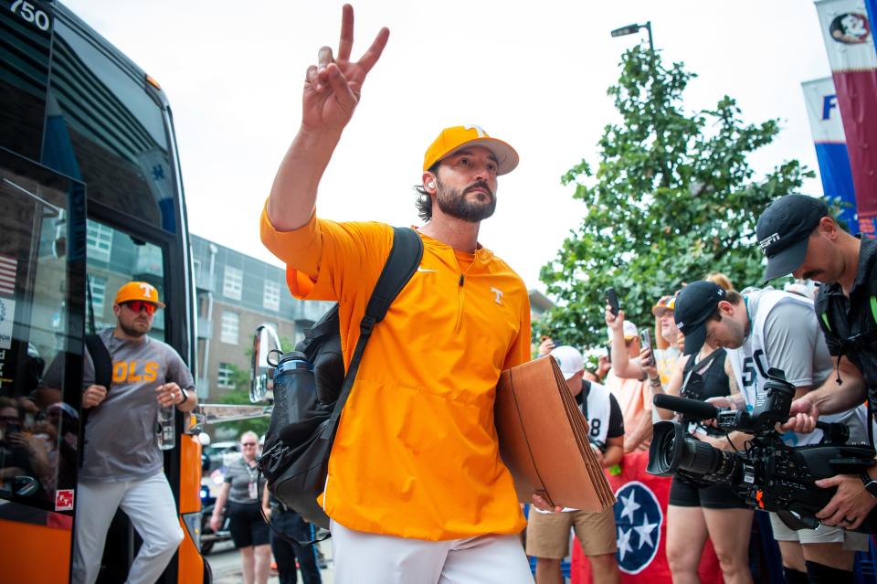 Tennessee head coach Tony Vitello acknowledges fans lined up for the Volunteers' arrival ahead of Saturday's Game 1 against Texas A&M in the College World Series championship series.