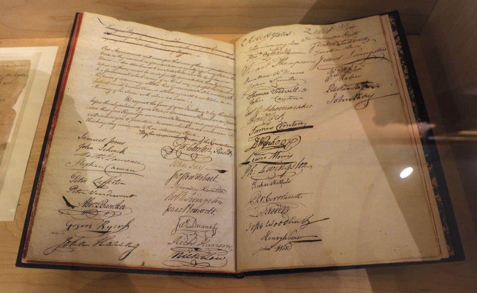 In this July 31, 2012 photo, signatures of delegates, including Alexander Hamilton and John Jay, who ratified the U.S. Constitution, fill pages of a convention journal on display at the Capitol in Albany, N.Y. Historic artifacts that have been kept in storage for years are now on display in the corridors of the Capitol and the adjacent Empire State Plaza. (AP Photo/Tim Roske)