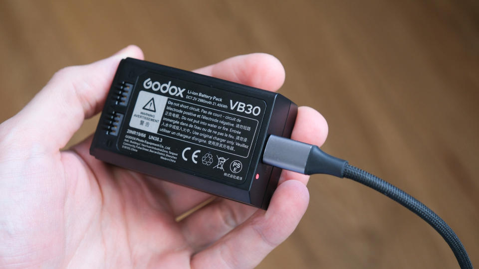 Godox V1Pro flashgun battery held in a hand