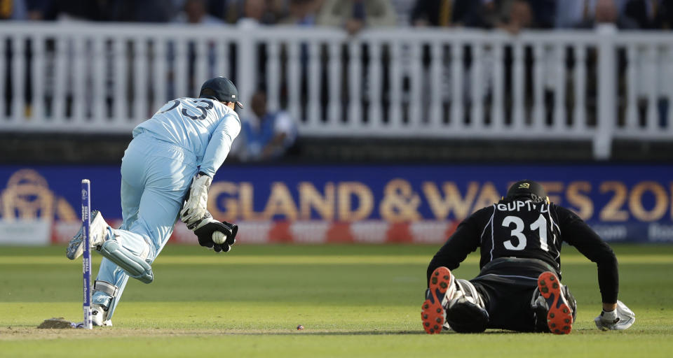 England's Jos Buttler runs out New Zealand's Martin Guptill to win the Cricket World Cup final match between England and New Zealand at Lord's cricket ground in London, Sunday, July 14, 2019. England won after a super over after the scores ended tied after 50 overs each. (AP Photo/Matt Dunham)