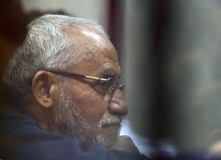 Muslim Brotherhood's Supreme Guide Mohamed Badie listens to lawyers as he sits behind bars during his trial with ousted Egyptian President Mohamed Mursi and other leaders of the brotherhood at a court in the police academy on the outskirts of Cairo December 14, 2014. REUTERS/Asmaa Waguih