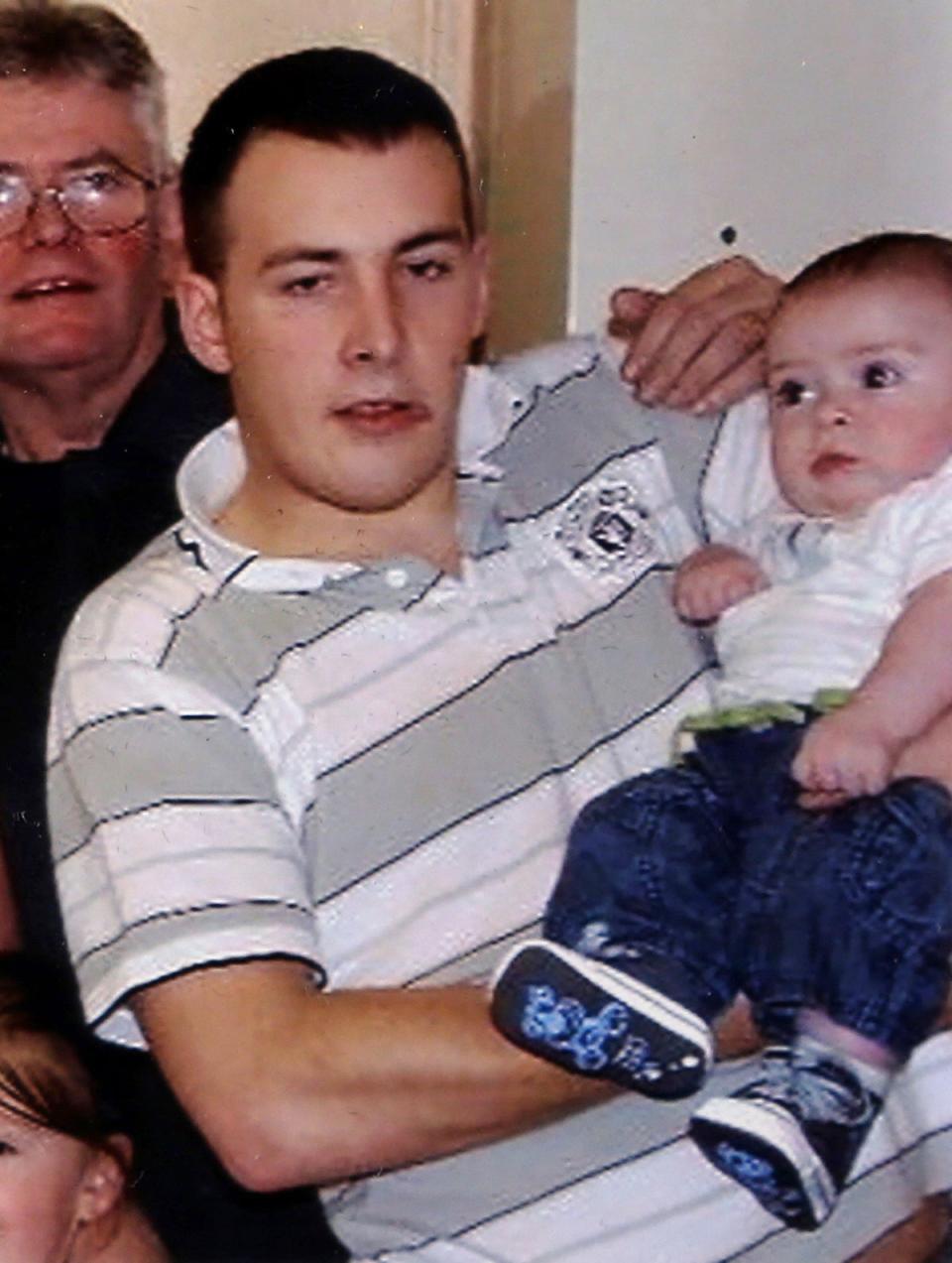 Jack Rigby as a baby, pictured with his father Lee (PA)