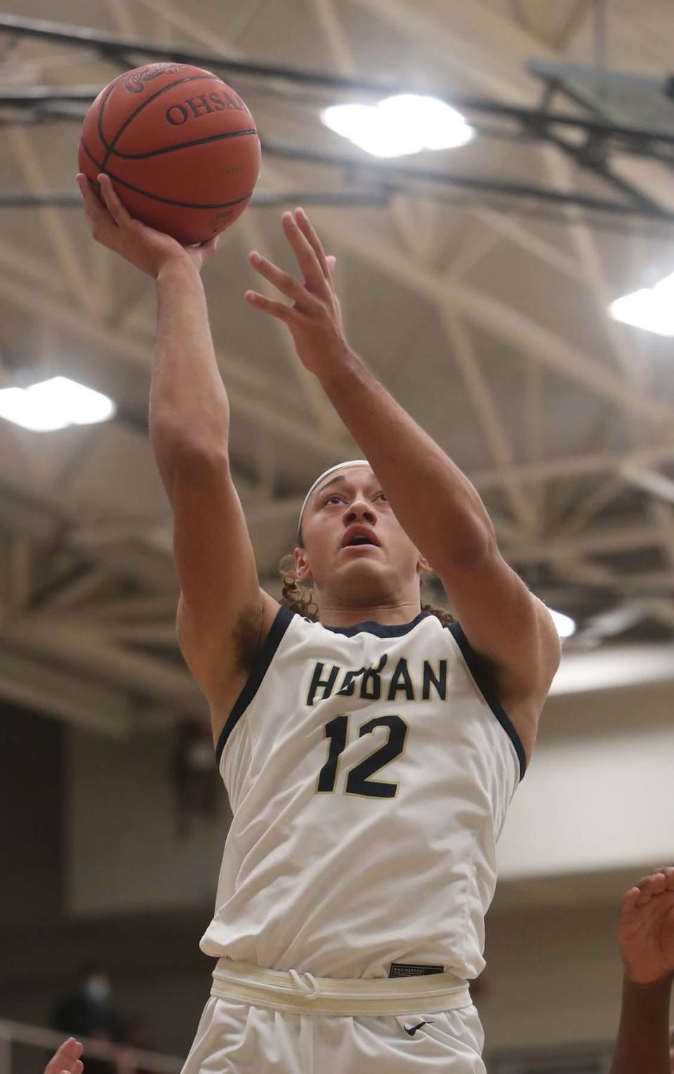 Archbishop Hoban's Jayvian Crable goes up for two points against Lakewood St. Edward during the first quarter of their Division I regional final Saturday at Copley. [Karen Schiely/Beacon Journal]