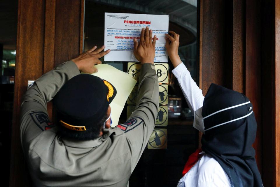 Municipal officers seal the Holywings bar (Reuters)