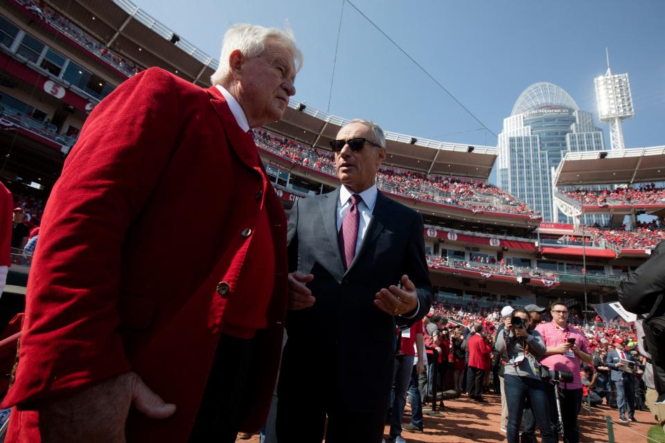 Rob Manfred, MLB commissioner, speaks to Cincinnati Reds CEO Bob Castellini before the Opening Day MLB baseball game between Cincinnati Reds and Pittsburgh Pirates on Thursday, March 28, 2019, at Great American Ball Park in Cincinnati.