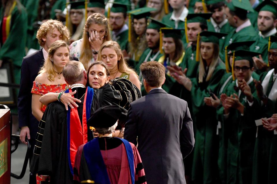 Riley Howell's mother, Natalie Henry-Howell hugs UNC Charlotte Chancellor Philip Dubois as she and her family are honored and her son is awarded with a B.A. in Memoriam during the University's Commencement ceremony for the College of Liberal Arts and Sciences in Charlotte on May 11, 2019. Riley Howell was killed in the April 30 shooting at the university.