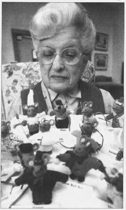 Agnes Edwards led the Mouse Factory for the St. Nicholas Faire annual Cathedral Mice for many years, pictured here with a handful of the mice in this 2002 file photo.