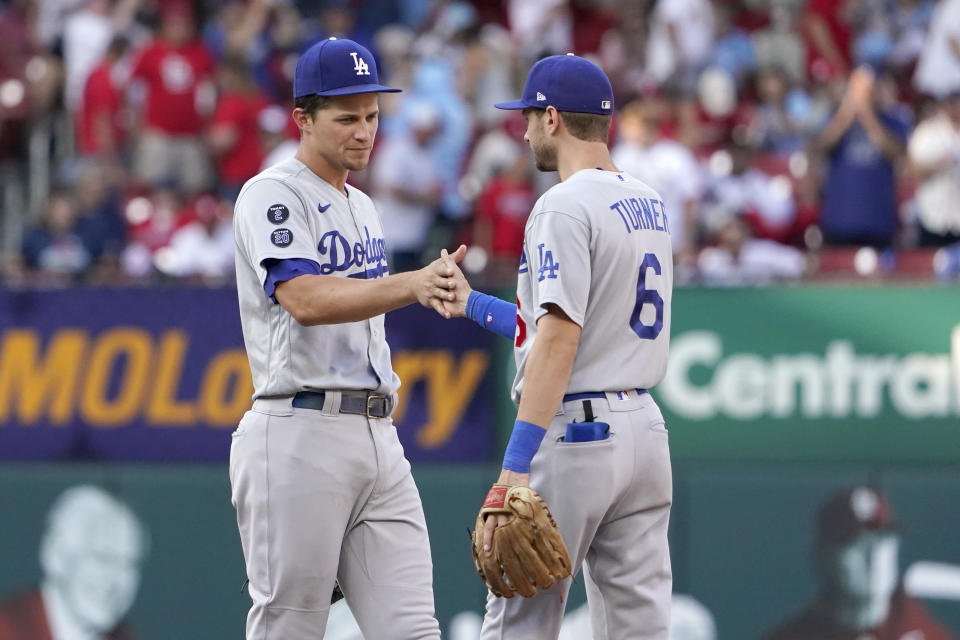 Los Angeles Dodgers' Corey Seager, left, and Trea Turner (6) celebrate a 5-1 victory over the St. Louis Cardinals in a baseball game Monday, Sept. 6, 2021, in St. Louis. (AP Photo/Jeff Roberson)