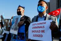 Ethnic Uyghur men take part in a protest against China