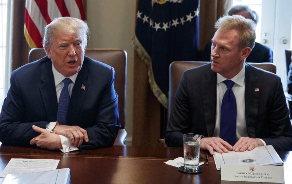 FILE - In this April 9, 2018, file photo, Deputy Secretary of Defense Patrick Shanahan, right, listen as President Donald Trump speaks during a cabinet meeting at the White House, in Washington. A U.S. administration official says that Defense Secretary Jim Mattis will leave his post Jan. 1, 2019, as Trump is expected to name Shanahan as acting secretary. (AP Photo/Evan Vucci, File)