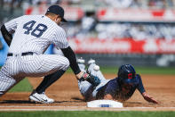 Cleveland Indians' Bradley Zimmer, right, dives safely into first base as New York Yankees' Anthony Rizzo tries to tag him out in the second inning of a baseball game, Sunday, Sept. 19, 2021, in New York. (AP Photo/Eduardo Munoz Alvarez)