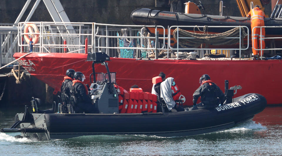 Border Force officers bring to shore men thought to be migrants in Dover, Kent, after small boat incidents in The Channel earlier this morning as the UK continues in lockdown to help curb the spread of the coronavirus.