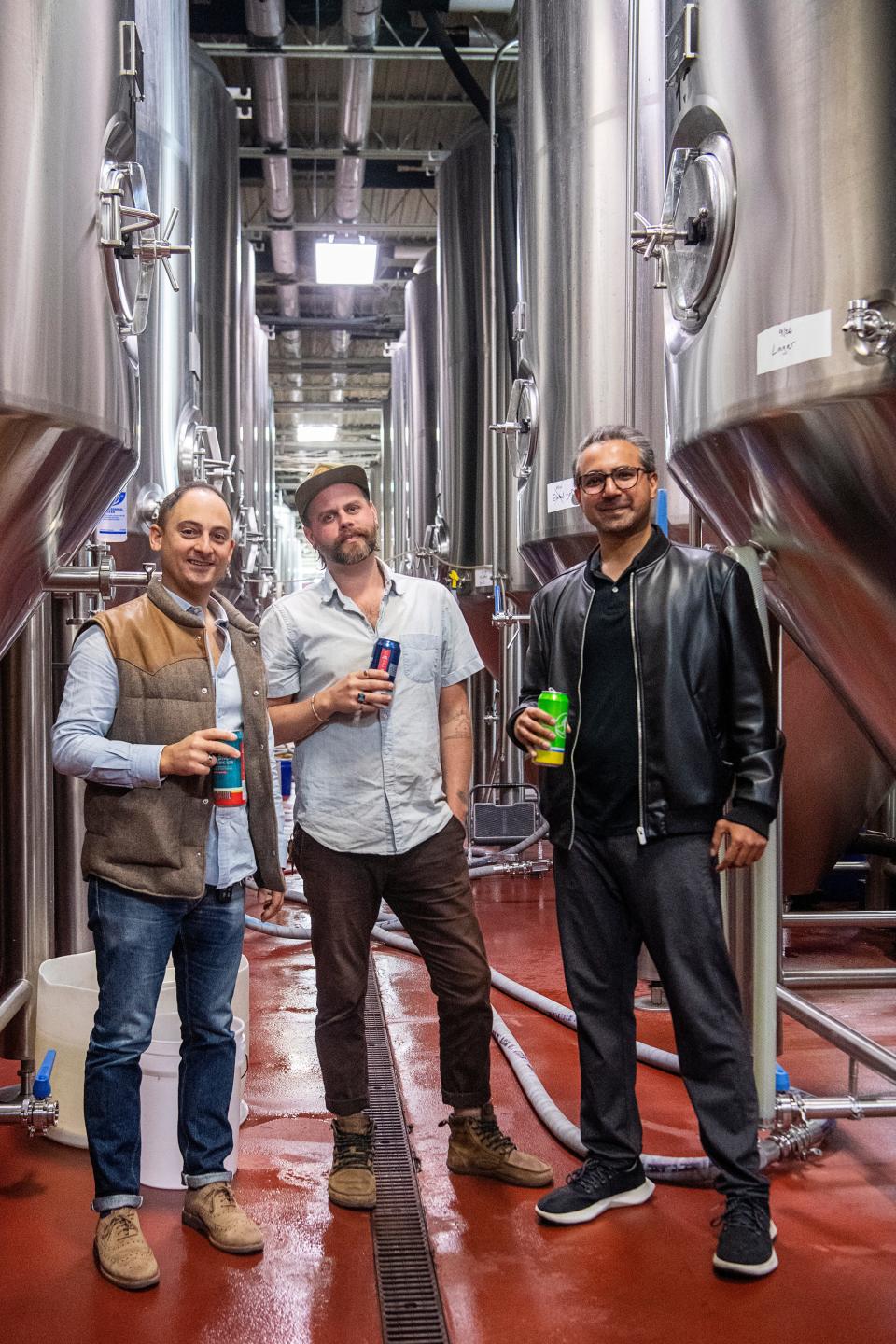 From left, Adam Charnack, co-owner of Hi-Wire Brewing, Christian Albrecht, co-founder and chef of Rebel Burger and Ali Amin, co-founder of Rebel Burger, at Hi-Wire, November 8, 2023.