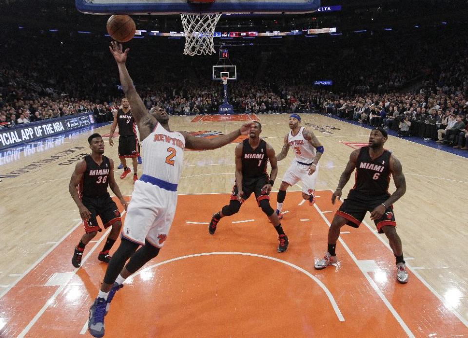 New York Knicks' Raymond Felton (2) scores as Miami Heat's Norris Cole (30), Chris Bosh (1), and LeBron James (6) watch during the first half of an NBA basketball game on Thursday, Jan. 9, 2014, in New York. (AP Photo/Frank Franklin II)