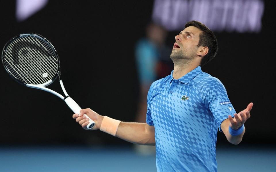 Serbia's Novak Djokovic reacts on a point against Spain's Roberto Carballes Baena during their men's singles match on day two of the Australian Open - Martin Keep/Getty Images