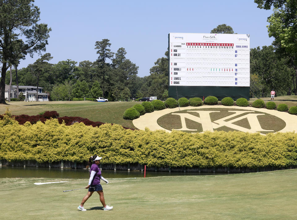 A golfer walks by the leaderboard on the 18th hole during the second round of the LPGA Tour's PureSilk Championship golf tournament Friday, May 21, 2021, in Williamsburg, Va. (Kaitlin McKeown/The Virginian-Pilot via AP)