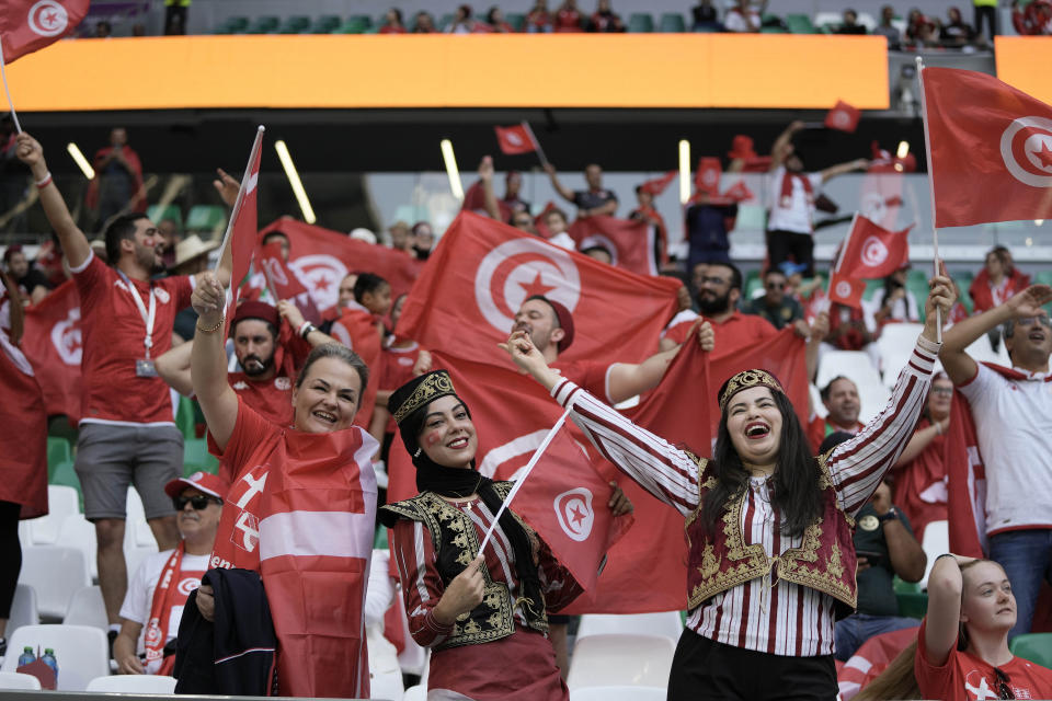 Soccer supporters cheer before the start of the World Cup group D soccer match between Denmark and Tunisia, at the Education City Stadium in Al Rayyan , Qatar, Tuesday, Nov. 22, 2022. (AP Photo/Hassan Ammar)