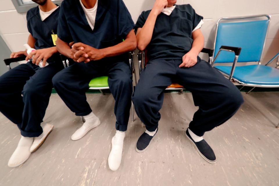 Detainees sit and wait for their turn at the medical clinic at the Winn Correctional Center in Winnfield, La., Thursday, Sept. 26, 2019.