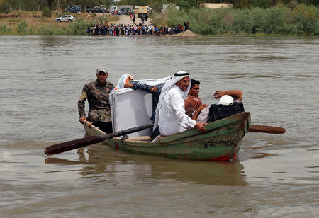 Displaced Iraqis cross the Tigris River by a boat after the bridge has been temporarily closed, in western Mosul, Iraq May 6, 2017. REUTERS/Suhaib Salem