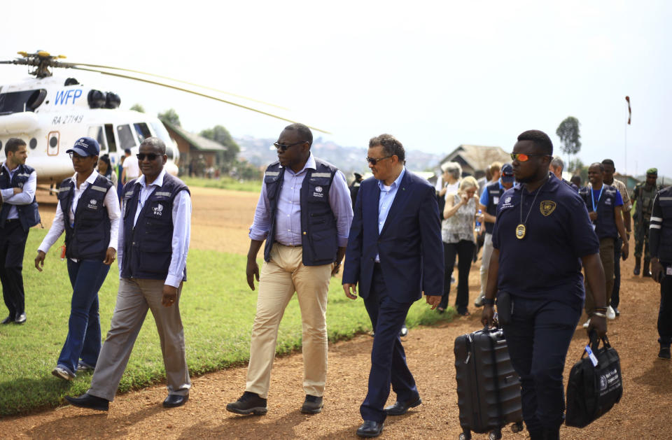 Director-General of the World Health Organization (WHO), Tedros Adhanom Ghebreyesus, center-right, arrives at Ruhenda airport in Butembo, to visit operations aimed at preventing the spread of Ebola and treating its victims, in eastern Congo Saturday, June 15, 2019. The World Health Organization on Friday said the Ebola outbreak is an "extraordinary event" of deep concern but does not yet merit being declared a global emergency, a declaration that typically triggers more funding, resources and political attention. (AP Photo/Al-hadji Kudra Maliro)