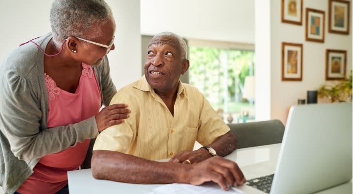 A couple looks over their retirement accounts together. 