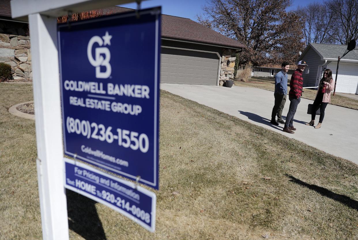 Coldwell Banker real estate agent Annie Beyersdorf meets with Robby Schroeder and Michael Jacobs before a home inspection on a home that the couple has an accepted offer to purchase on March 28, 2022, in Grand Chute, Wis. Three months ago, they sold their home and started to hunt for a new, larger one with character inside and out. It took them three months, almost 30 private visits and open houses, and four offers before they were able to land a home.