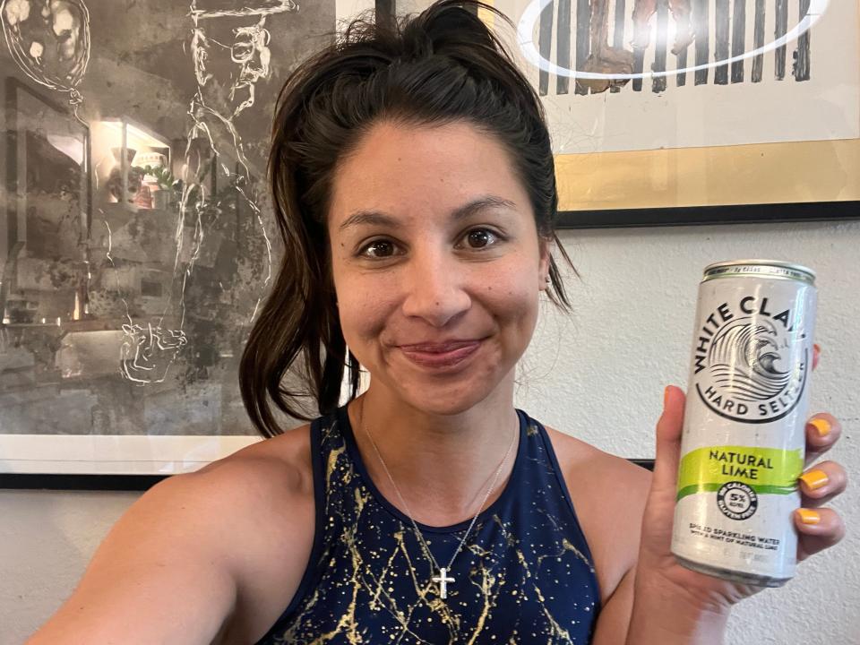 chelsea holding a can of lime white claw hard seltzer