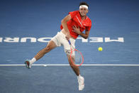 Taylor Fritz of the U.S. makes a forehand return to Stefanos Tsitsipas of Greece during their fourth round match at the Australian Open tennis championships in Melbourne, Australia, Monday, Jan. 24, 2022. (AP Photo/Andy Brownbill)