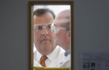 New Jersey Governor Chris Christie wears safety glasses during his visit to the One Nucleus life science company headquarters in Cambridge, eastern England February 2, 2015. REUTERS/Neil Hall