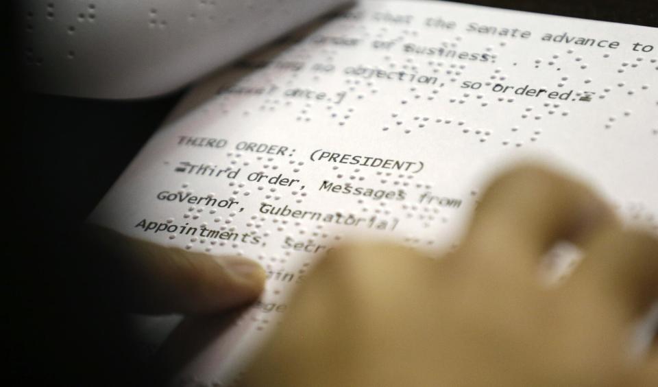 Washington Lt. Gov.-elect Cyrus Habib reads braille as he goes over a test script for some of his duties as President of the Senate, Thursday, Jan. 5, 2017, during a practice session to test technical equipment in Olympia, Wash. Habib will be Washington's first blind lieutenant governor, and the Senate has undergone a makeover that incorporates Braille into that chamber's floor sessions that will allow Habib to know by the touch of his finger which lawmaker is seeking to be recognized to speak. Habib is replacing Lt. Gov. Brad Owen, who is retiring. (AP Photo/Ted S. Warren)