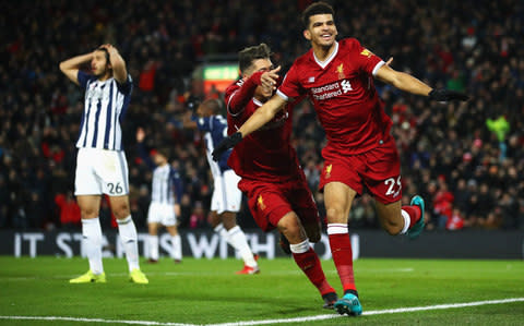 Dominic Solanke celebrates after scoring his side's first goal with Roberto Firmino of Liverpool but it is later disallowed during the Premier League match between Liverpool and West Brom - Credit: Getty Images 