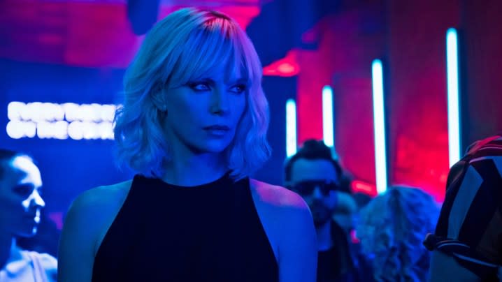 Charlize Theron as a covert agent in a neon-lit club in Atomic Blonde.