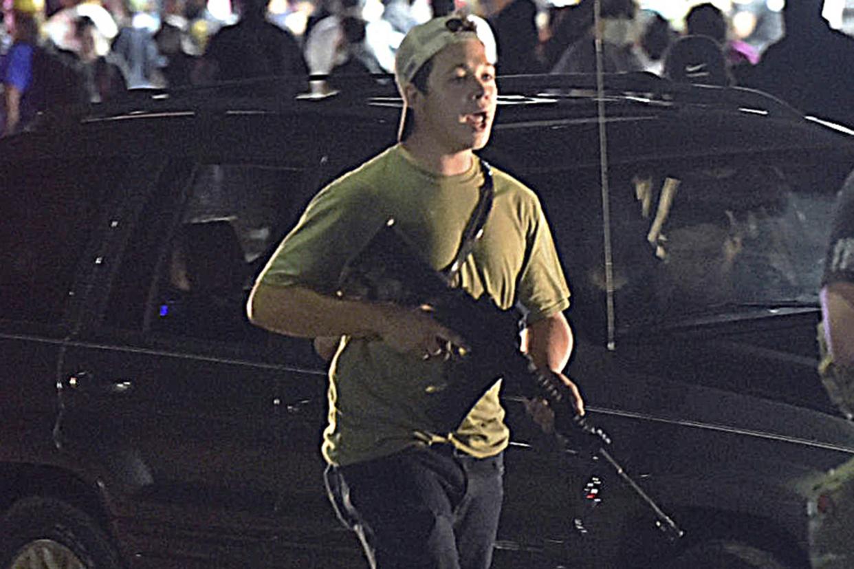 Kyle Rittenhouse carries the rifle on Aug. 25, 2020, the night he killed two people, in Kenosha, Wis.