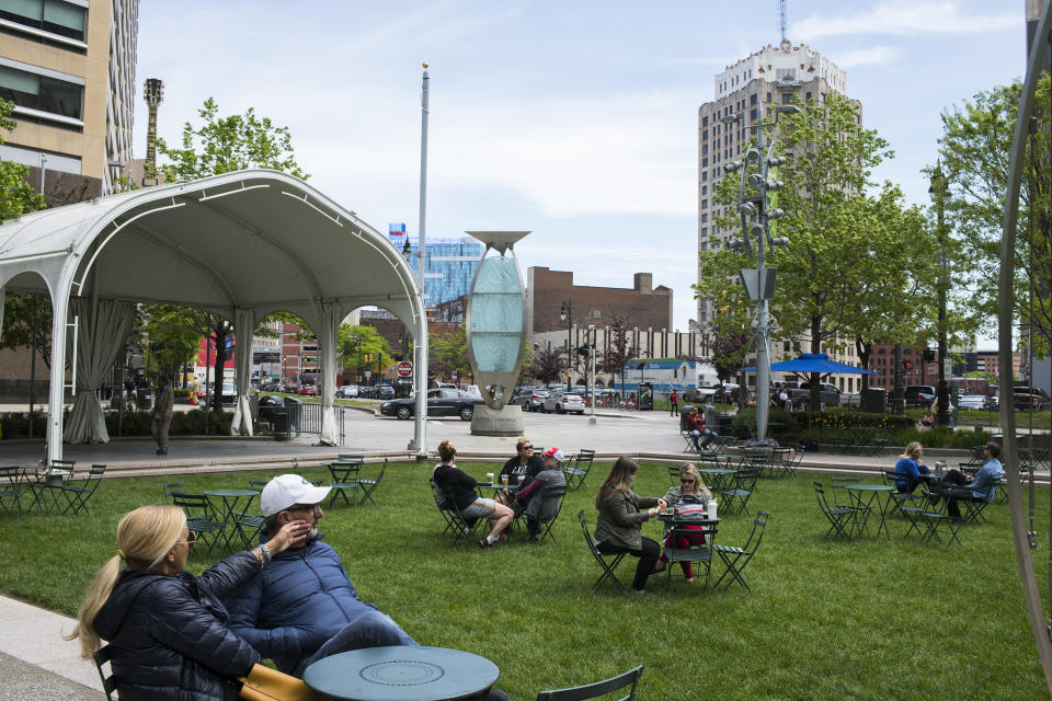 Locals enjoy Campus Martius, a Detroit public park where billionaire Dan Gilbert’s office sits. Gilbert now owns a large share of the buildings in downtown. (Photo: Brittany Greeson for Yahoo News)