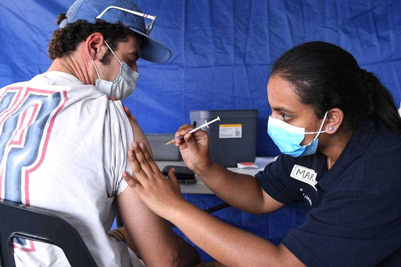 Resident Mark Simpson receives a COVID-19 vaccination at a pop-up clinic at Bunnings Mt Gravatt in Brisbane