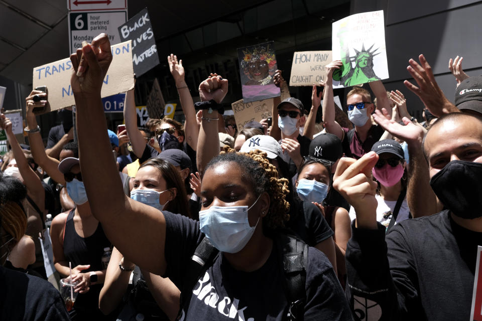 Protesters rally near the edge of Times Square in New York, Sunday, June 7, 2020. New York City lifted the curfew spurred by protests against the death of George Floyd and police brutality ahead of schedule Sunday after a peaceful night, free of the clashes or ransacking of stores that rocked the city days earlier. (AP Photo/Seth Wenig)