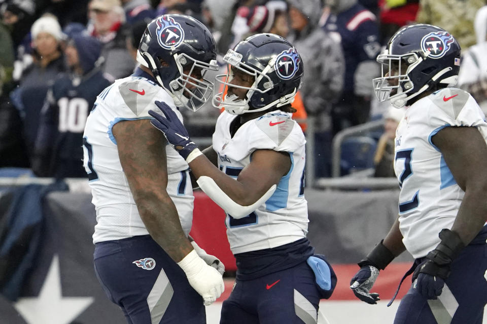 Tennessee Titans running back Dontrell Hilliard, center, is congratulated after his 68-yard touchdown run during the first half of an NFL football game against the New England Patriots, Sunday, Nov. 28, 2021, in Foxborough, Mass. (AP Photo/Mary Schwalm)