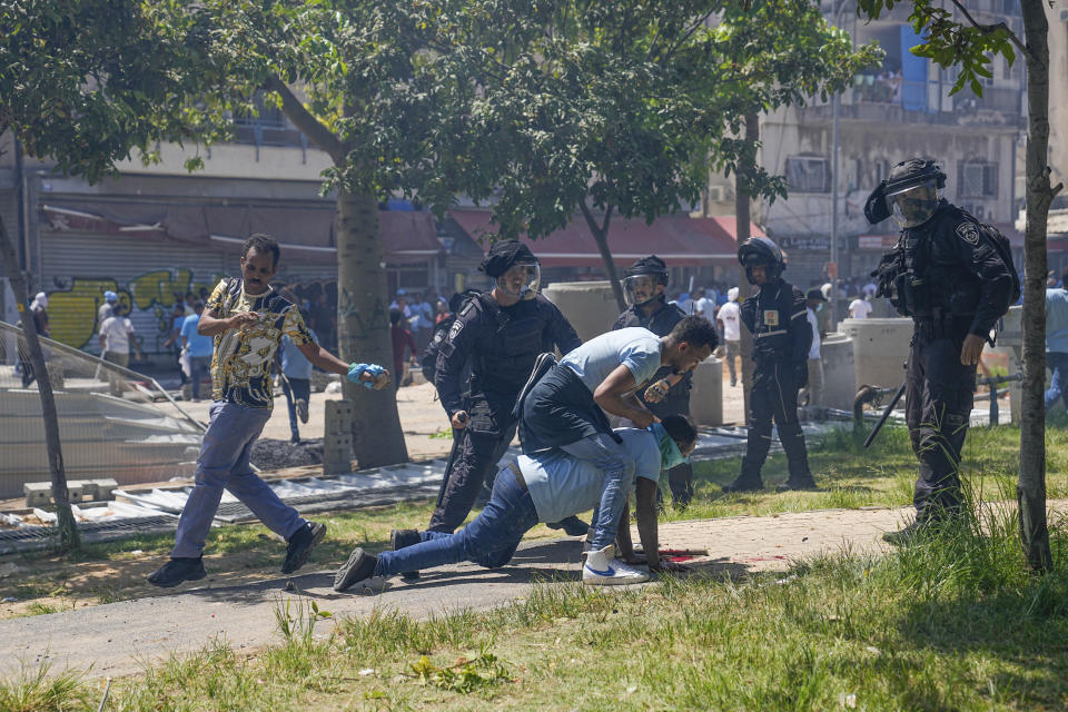 Eritrean protesters clash with Israeli riot police in Tel Aviv, Israel, Saturday, Sept. 2, 2023. Hundreds of Eritrean asylum seekers smashed shop windows and police cars in Tel Aviv on Saturday and clashed with police during a protest against an event organized by the Eritrea Embassy. The Israeli police said 27 officers were injured in the clashes, and at least three protesters were shot when police opened fire with live rounds when they felt "real danger to their lives." (AP Photo/Ohad Zwigenberg)