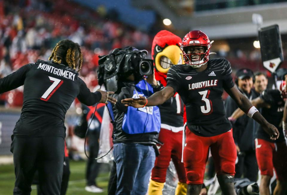 Louisville's Malik Cunningham gets a hand from teammate Monty Montgomery who is on the injured list at Cardinal Stadium Saturday. UofL beat Boston College and is now 4-3 and breaks a two-game losing streak. Oct. 23, 2021