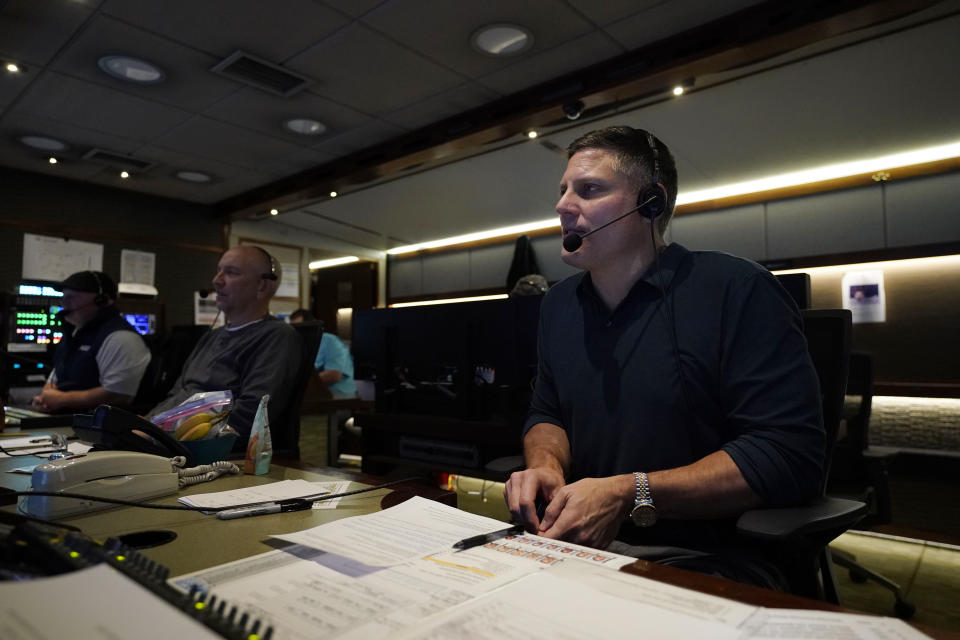 Producer Robert Hyland, right, and director Drew Esocoff work inside the NBC Sports trailer in preparation for the network's "Sunday Night Football" broadcast, before an NFL football game between the Los Angeles Chargers and the Miami Dolphins on Dec. 11, 2022, in Inglewood, Calif. “Sunday Night Football” is on pace to be prime time's top show for the 12th consecutive year. (AP Photo/Jae C. Hong)