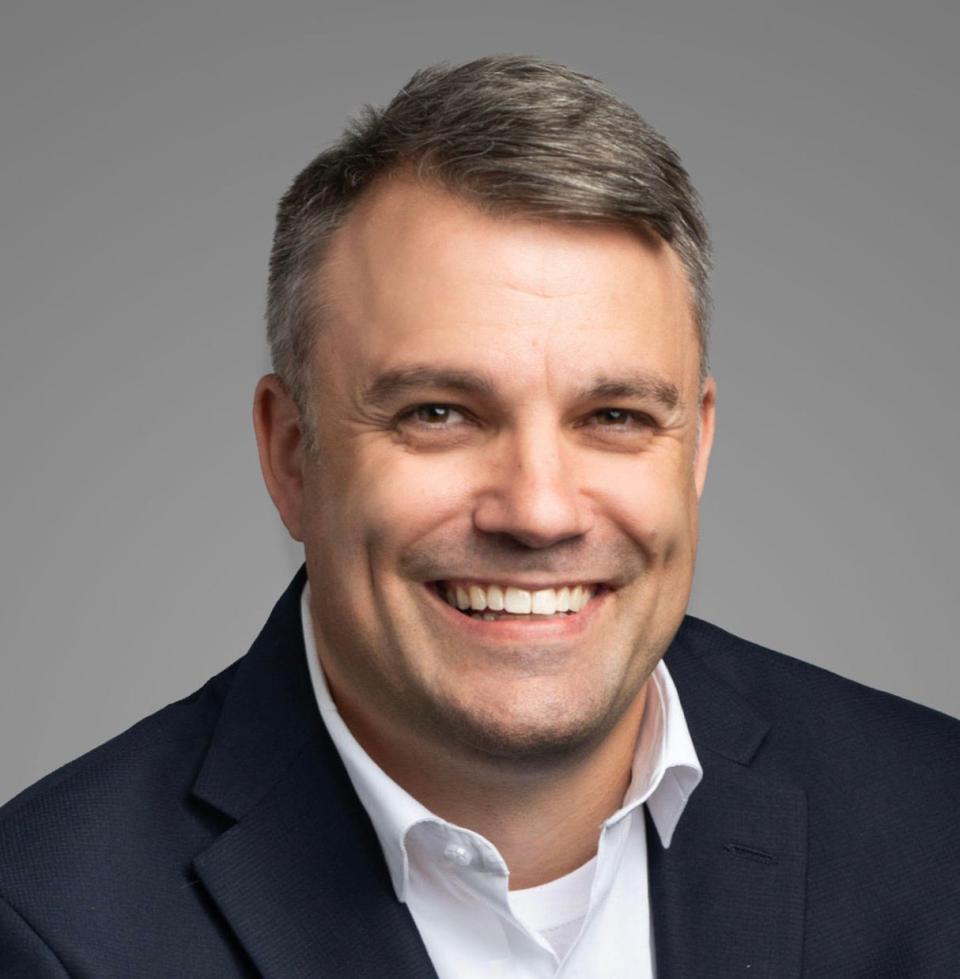 headshot of Karl Wendt wearing a dark blazer over a white button-up