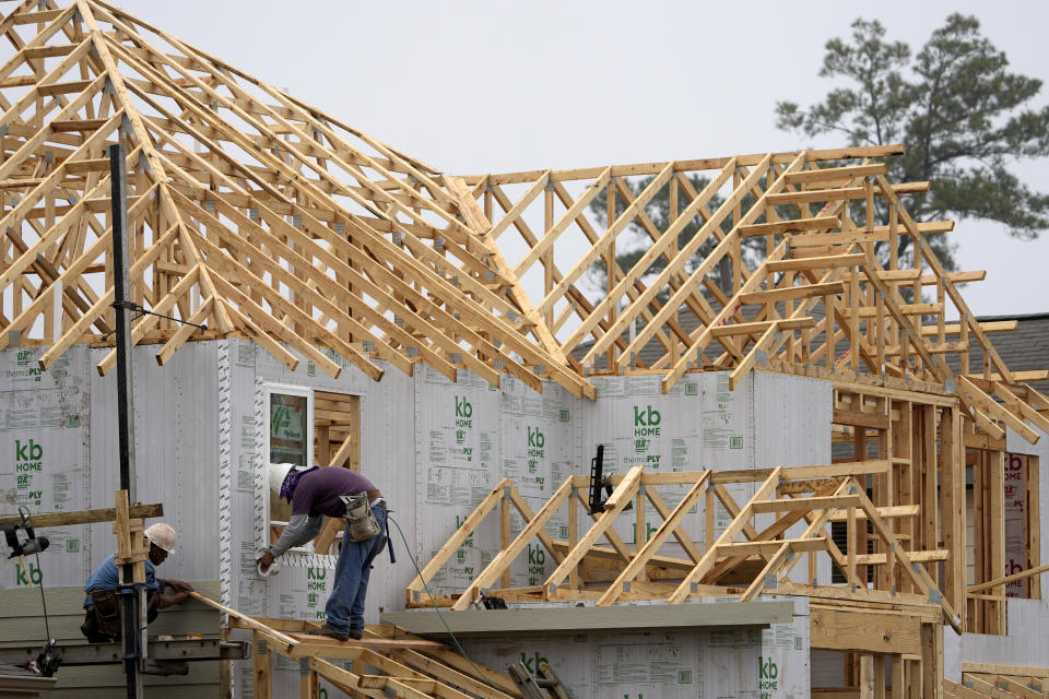 Construction workers build a new home Monday, March 15, 2021, in Houston. U.S. construction spending rose a modest 0.2% gain in April as strength in housing offset further weakness in nonresidential construction. (AP Photo/David J. Phillip)