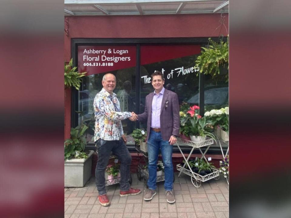 Ernie Klassen, president of the White Rock Pride Society, left, shakes hands with James Borkowski with the Roman Catholic Archdiocese of Vancouver. The archdiocese has apologized to the society for stopping a 2019 event. (Roman Catholic Archdiocese of Vancouver - image credit)