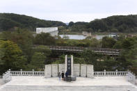 South Korean visitors pay respect to their ancestors in North Korea to celebrate the Chuseok, the Korean version of Thanksgiving Day, at Imjingak Pavilion in Paju, near the border with North Korea, South Korea, Thursday, Oct. 1, 2020. The government has discouraged people from visiting their hometowns for the Chuseok holiday amid concerns about the spread of the coronavirus. The monument reads: "Worship from a distance." (AP Photo/Ahn Young-joon)