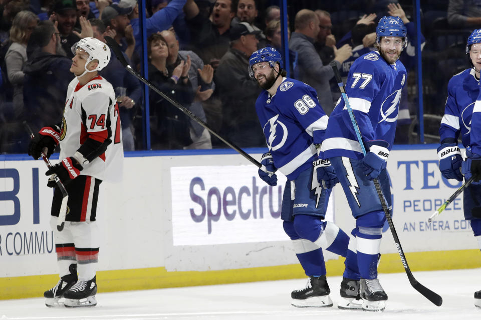 Tampa Bay Lightning right wing Nikita Kucherov (86) celebrates his goal against the Ottawa Senators with defenseman Victor Hedman (77) during the first period of an NHL hockey game, Tuesday, Dec. 17, 2019, in Tampa, Fla. (AP Photo/Chris O'Meara)
