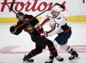 Ottawa Senators defenseman Thomas Chabot (72) and Washington Capitals right wing Garnet Hathaway (21) get tangled up mid ice during the second period of an NHL hockey game in Ottawa, Ontario on Monday, Oct. 25, 2021. (Justin Tang/The Canadian Press via AP)