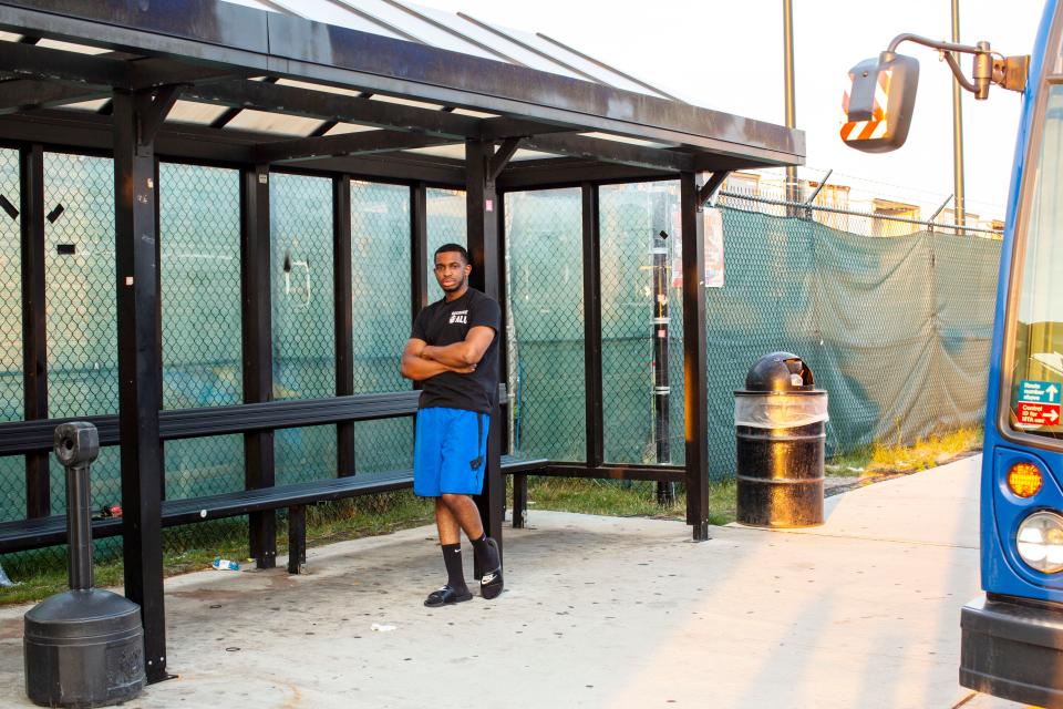 Derrick Palmer standing at a bus stop near the Amazon JFK8 warehouse