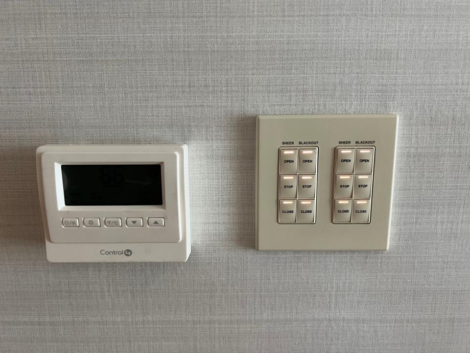 Control panels on a wall for AC, heat, and windows.