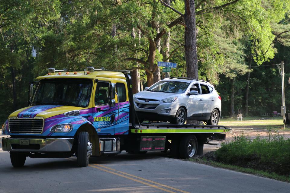 A tow truck taking away a vehicle from the scene of a police stand-off that ended when a woman shot herself after firing towards law enforcement on Thursday April 28, 2022.